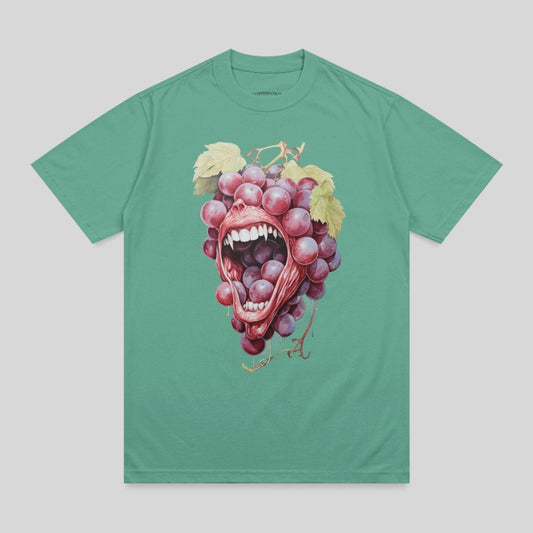Grapes spilling from an open mouth with teeth on a teal t-shirt.