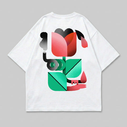 White t-shirt with geometric floral graphic design in pink, red, green, and black.