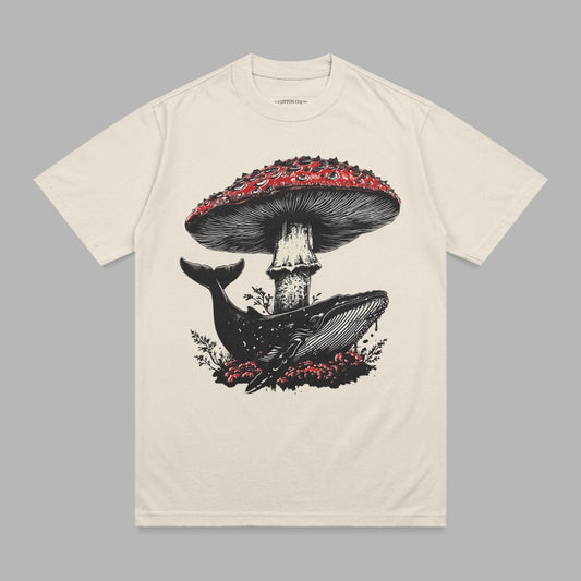Cream t-shirt with whale under a red mushroom graphic.