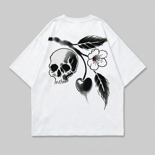 White t-shirt with black skull, cherry, and floral design.
