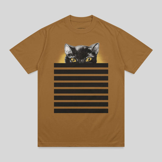Black cat with yellow eyes peeking over horizontal black stripes on a brown t-shirt.