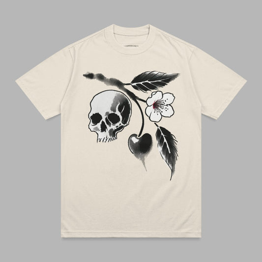 Cream t-shirt with a black and white skull and cherry blossom branch graphic.
