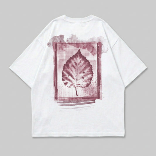 White t-shirt with a reddish-brown leaf print in a watercolor frame.
