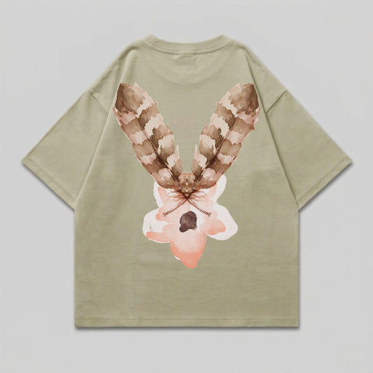 Tan t-shirt with a watercolor-style feather and flower design on the back.