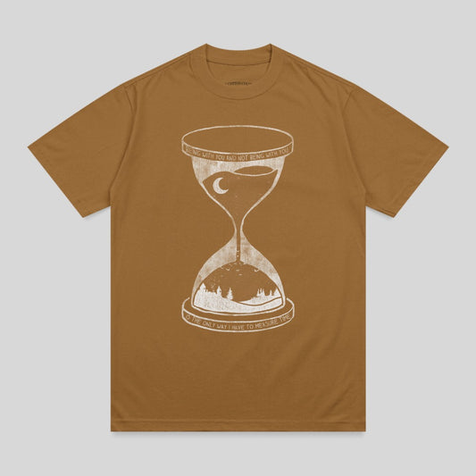 Brown t-shirt with hourglass and landscape graphic and text.