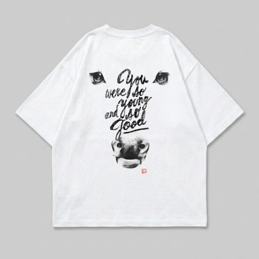 White t-shirt with a black ink drawing of a cow's head and text.