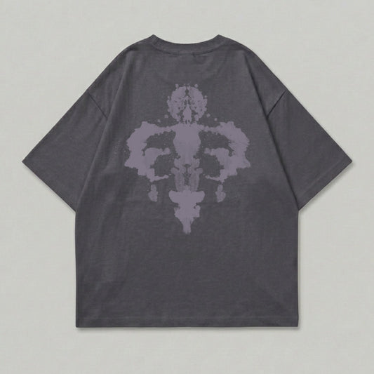 Dark grey t-shirt with symmetrical purple ink-blot design on back.