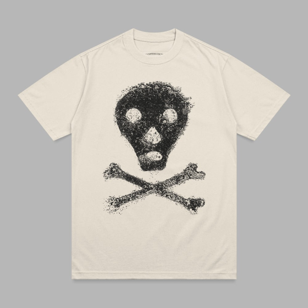 Cream t-shirt with distressed black skull and crossbones graphic.