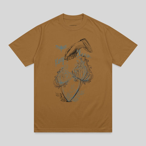 Brown t-shirt with a line drawing of a hand pouring water over two flowers.
