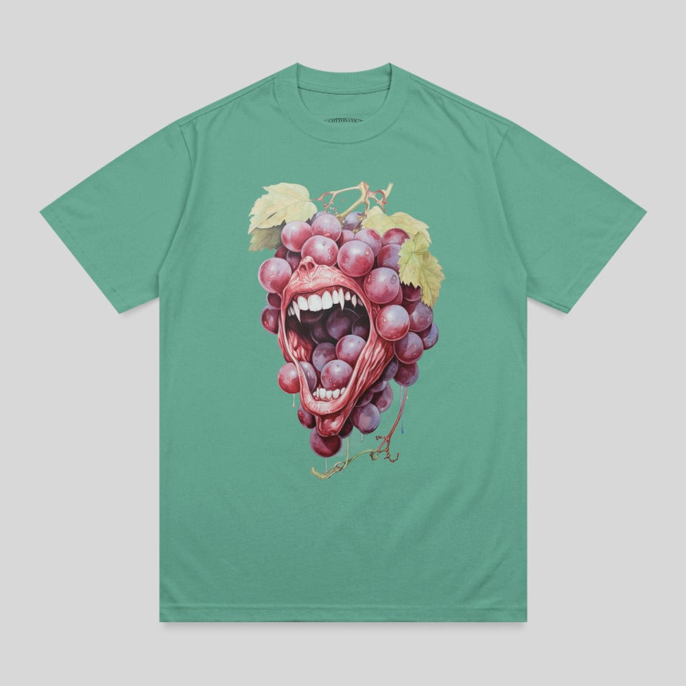 Grapes spilling from an open mouth with teeth on a teal t-shirt.