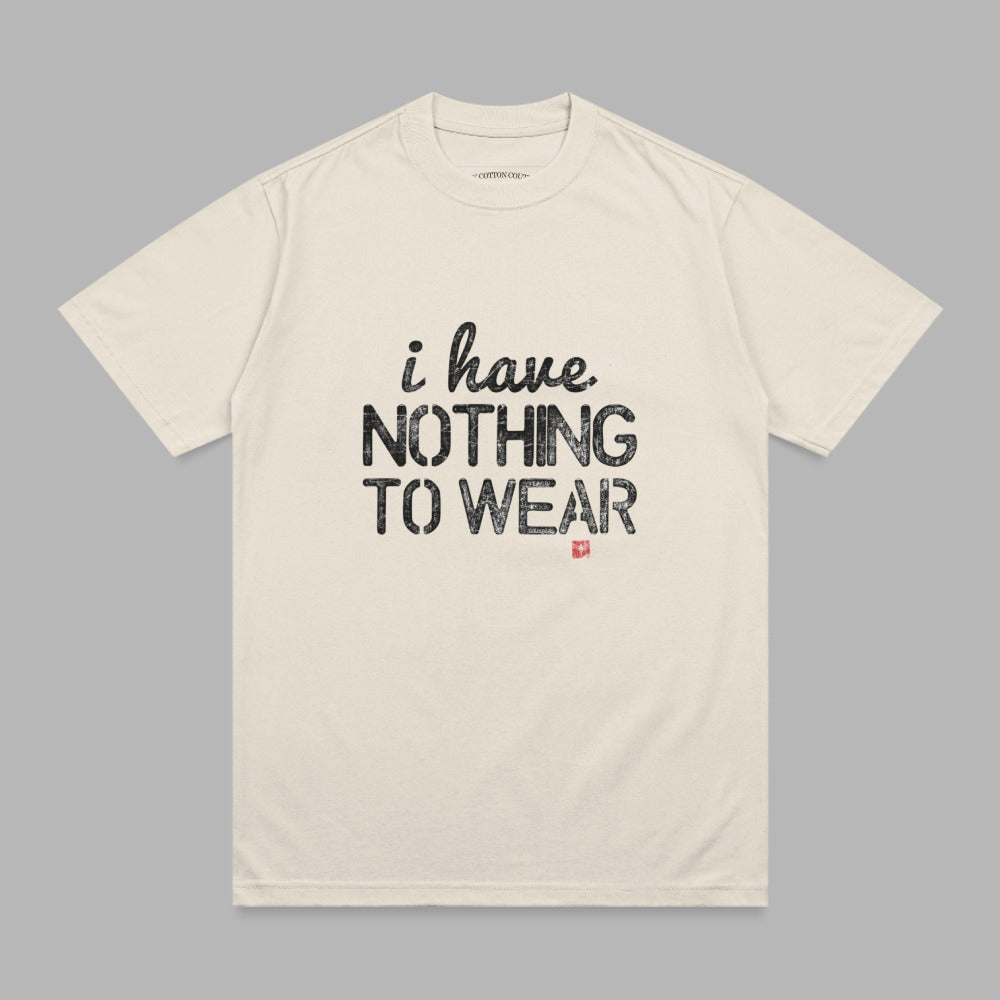 Cream t-shirt with "i have. NOTHING TO WEAR" printed in black text.