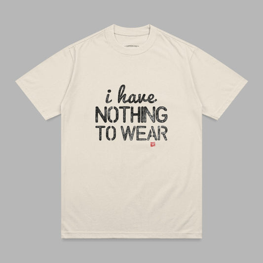 Cream t-shirt with "i have. NOTHING TO WEAR" printed in black text.
