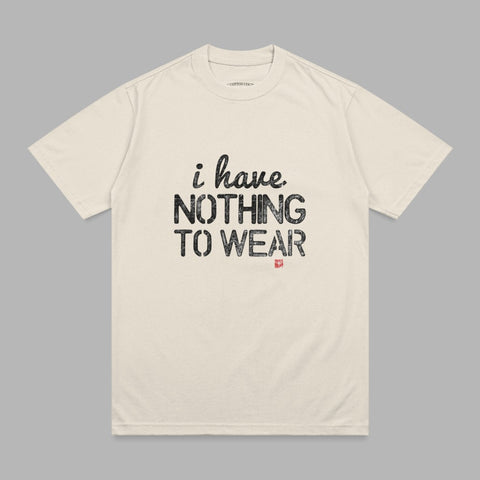 Cream t-shirt with "i have. NOTHING TO WEAR" printed in black text.