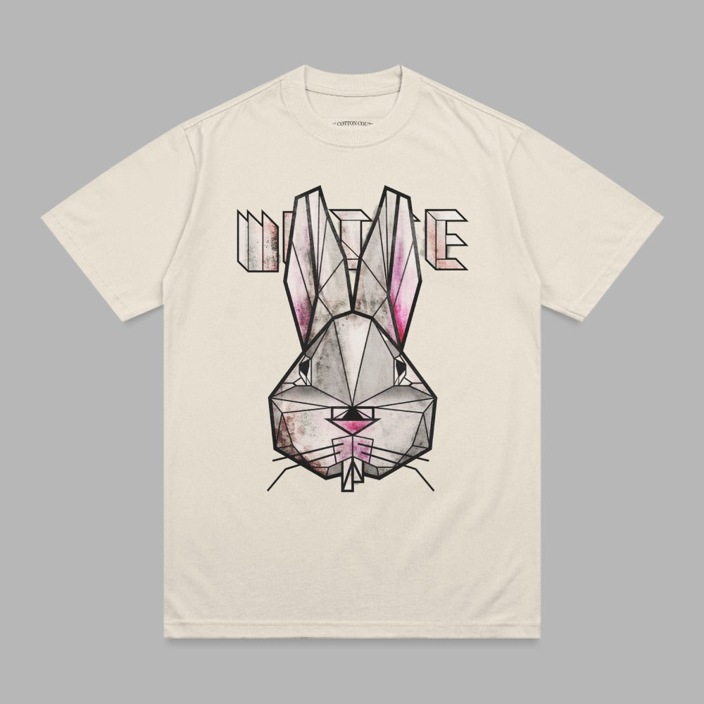 Cream t-shirt featuring a geometric, pink and black bunny face graphic with "WHITE" text.