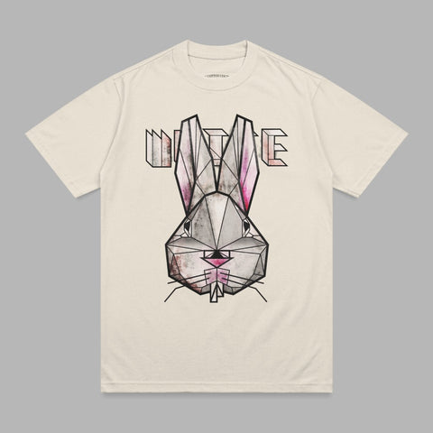 Cream t-shirt featuring a geometric, pink and black bunny face graphic with "WHITE" text.