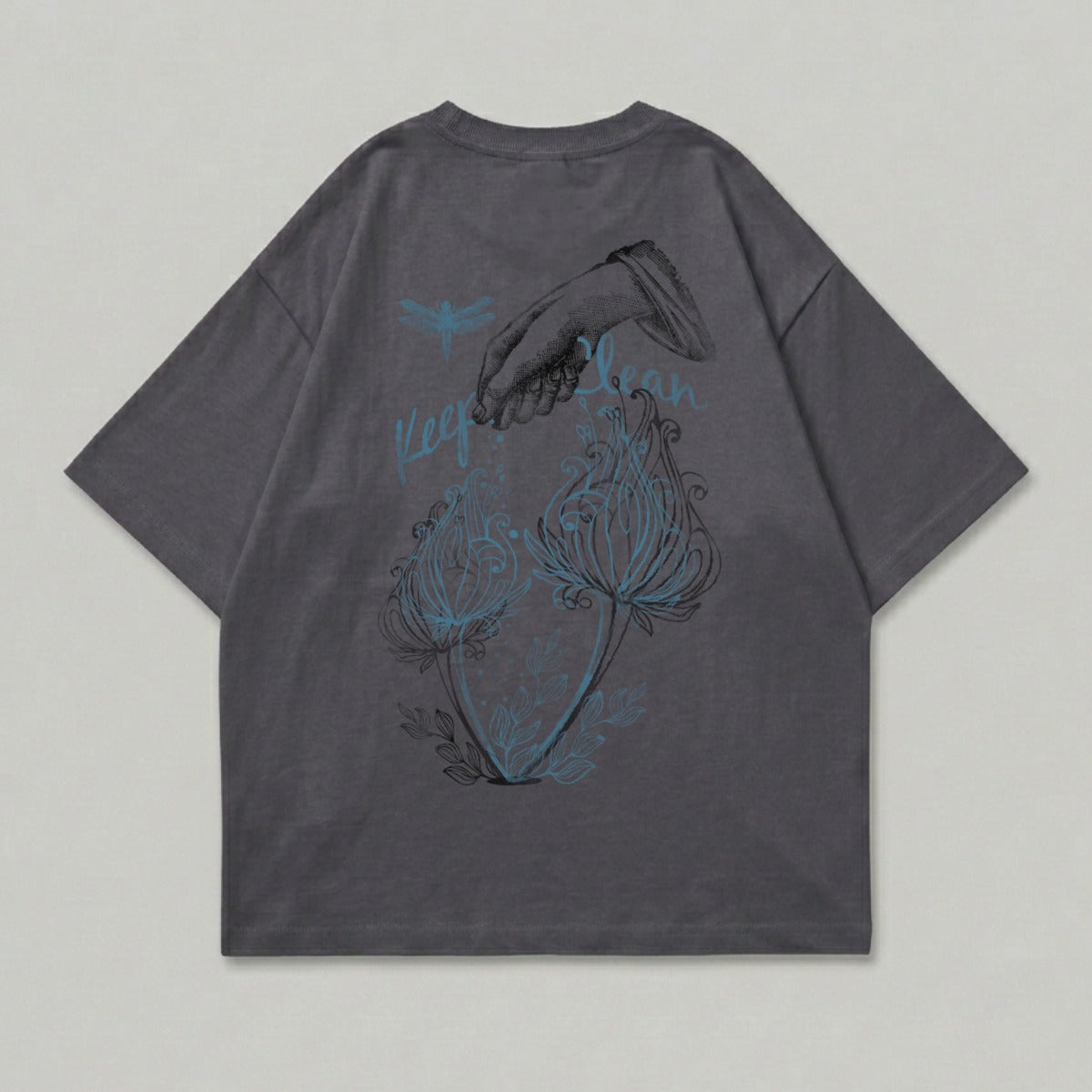Dark gray t-shirt with dragonfly, hand sprinkling flowers, and "Keep Calm" text.