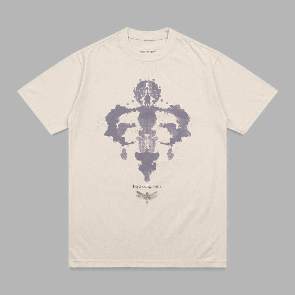 Cream t-shirt with Rorschach inkblot and dragonfly graphic.