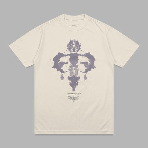 Cream t-shirt with Rorschach inkblot and dragonfly graphic.