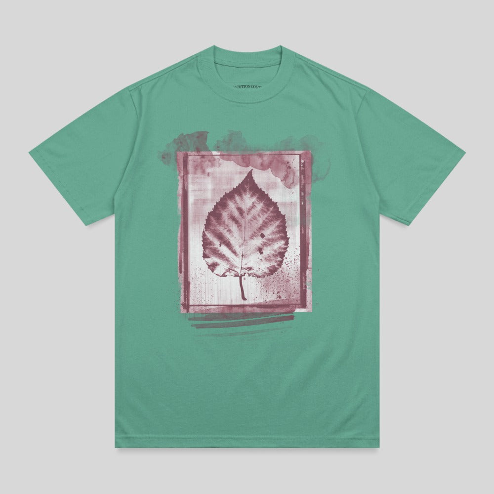 Teal t-shirt with a dark red leaf print inside a watercolor-style frame.