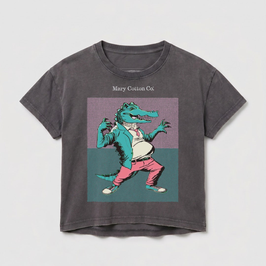 Anthropomorphic alligator in a suit and tie, standing with hands on hips.
