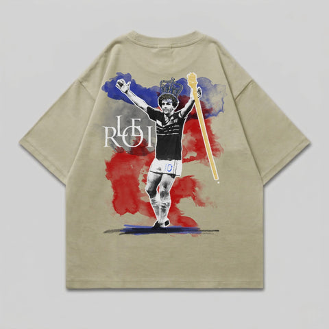 T-shirt with a graphic of a soccer player wearing a crown and holding a scepter.