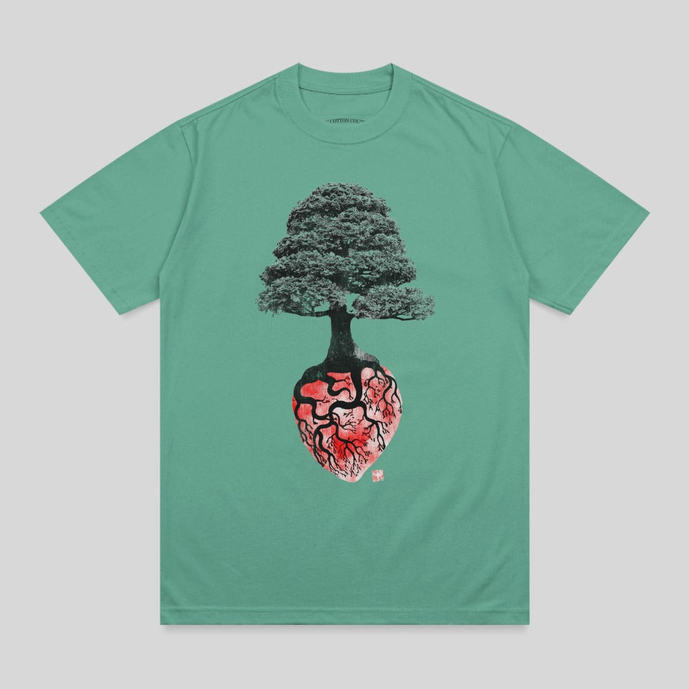 Green t-shirt with anatomical heart and tree graphic.