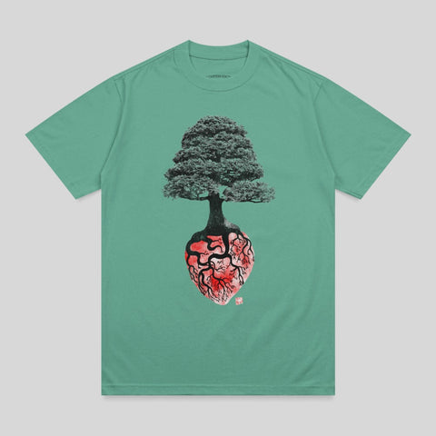 Green t-shirt with anatomical heart and tree graphic.