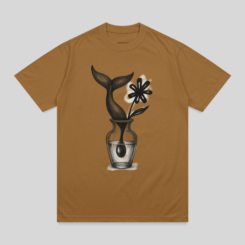 Whale tail and flower in a vase graphic on a brown t-shirt.