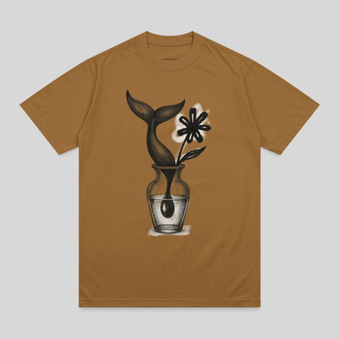 Whale tail and flower in a vase graphic on a brown t-shirt.