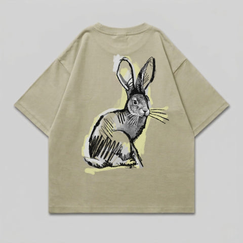 Beige t-shirt with a sketched rabbit graphic on the back.