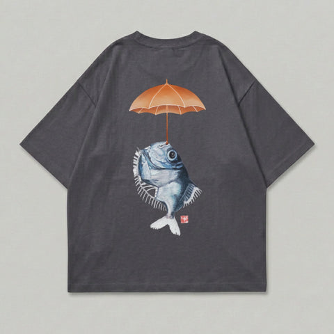 T-shirt with graphic of a fish holding an umbrella over its head.