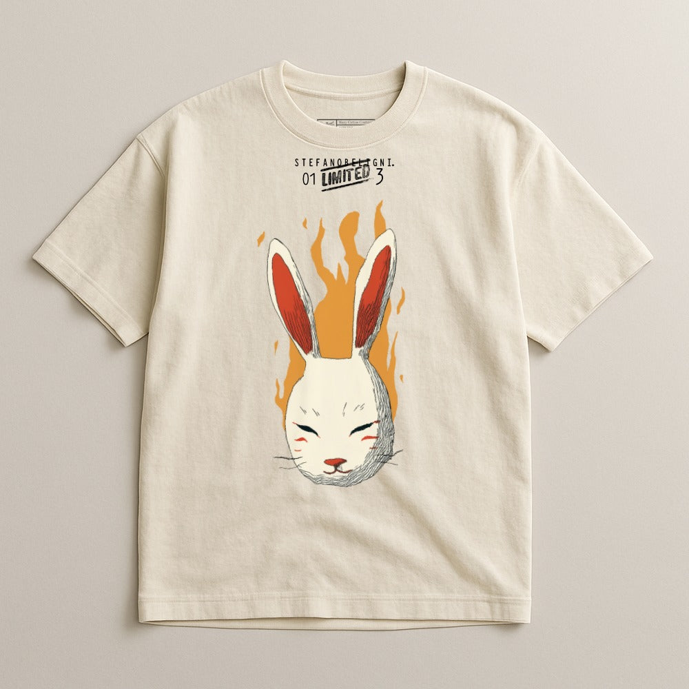 Cream t-shirt with a sketched white rabbit mask with orange ears on fire.