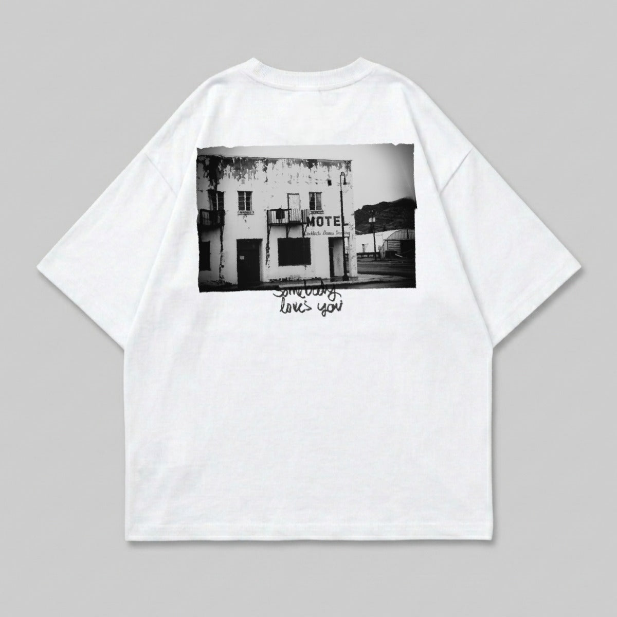 White t-shirt with black and white photograph of a motel and text.
