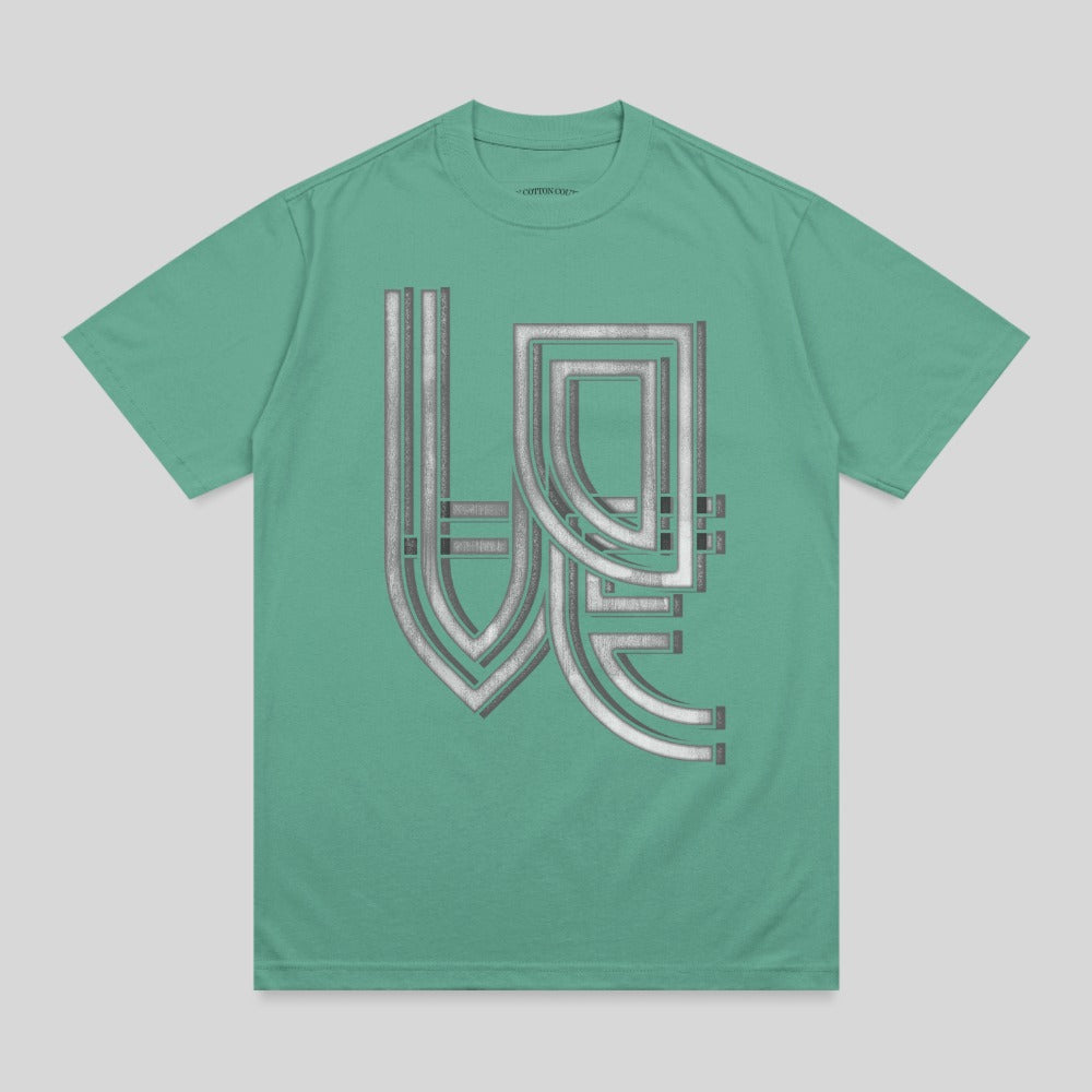 Green t-shirt with metallic silver geometric design in the center.