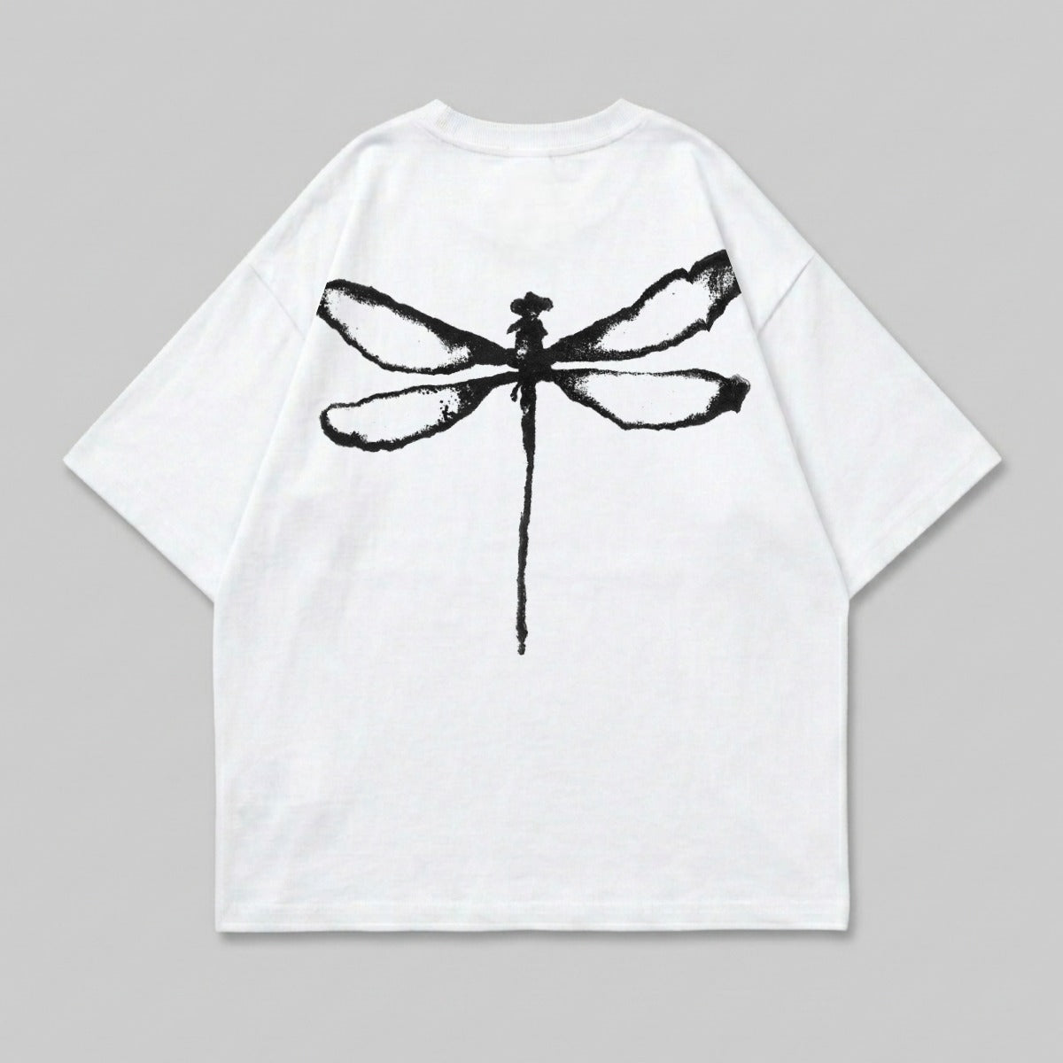 White t-shirt with a black dragonfly graphic on the back.