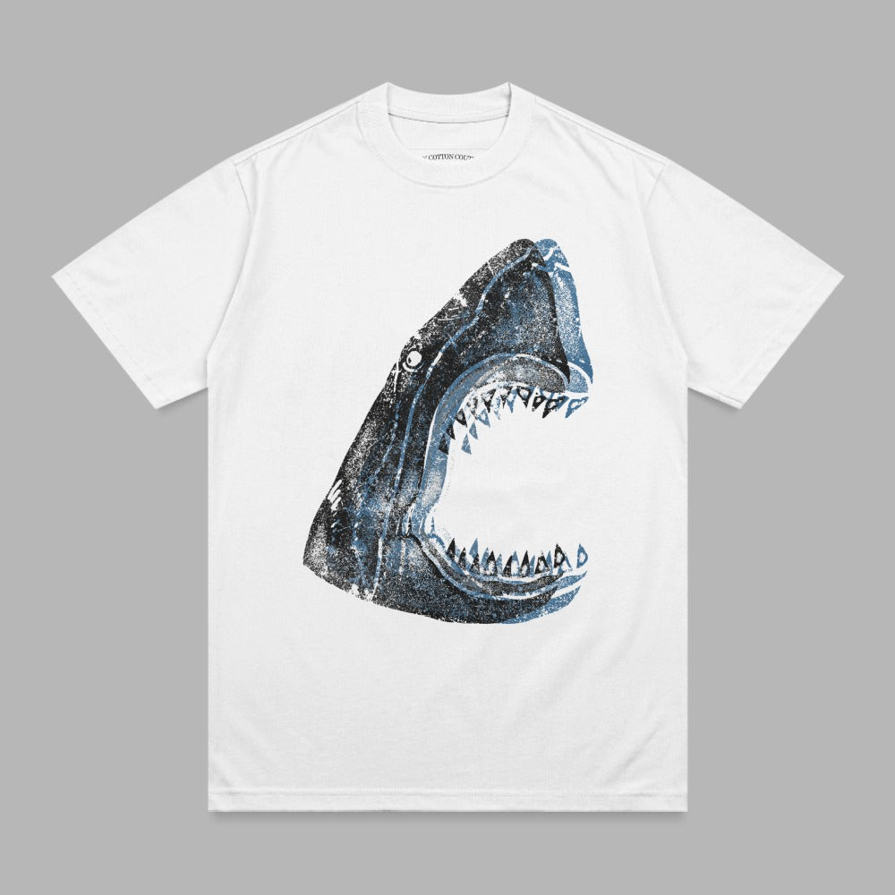 White t-shirt with a distressed, open-mouthed shark graphic in blue and black.