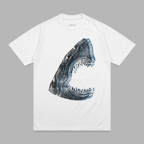 White t-shirt with a distressed, open-mouthed shark graphic in blue and black.