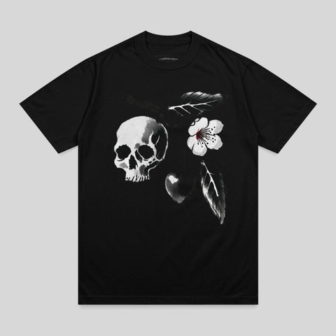 Black t-shirt with a skull, flower, and feather design.