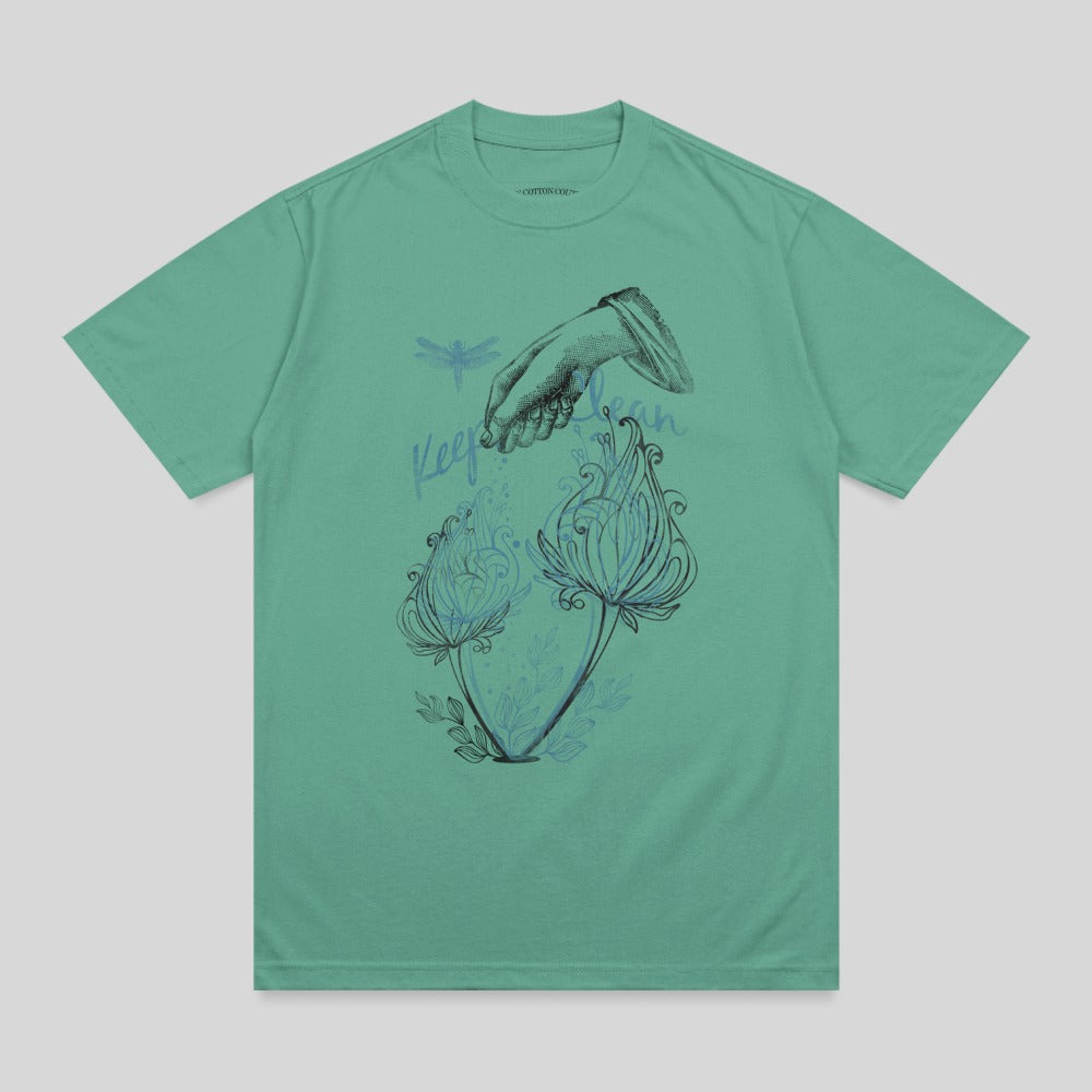 T-shirt with hand reaching for two blue flowers and dragonfly.