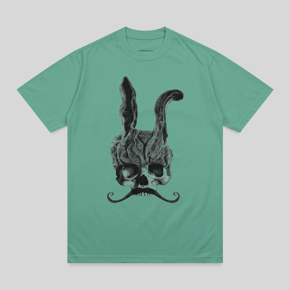 Skull with bunny ears and a mustache on a teal t-shirt.