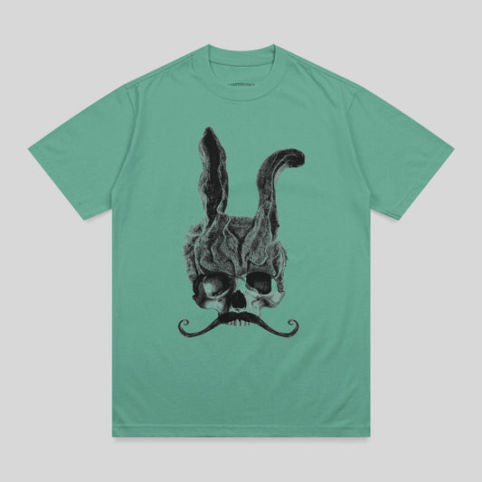 Skull with bunny ears and a mustache on a teal t-shirt.