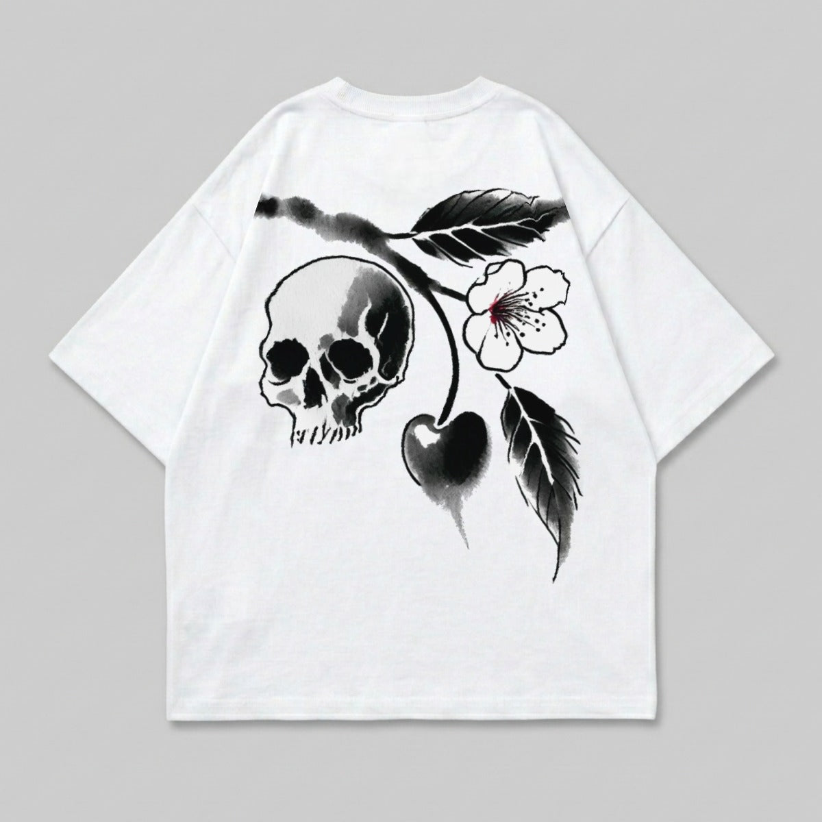 White t-shirt with black skull, cherry, and floral design.