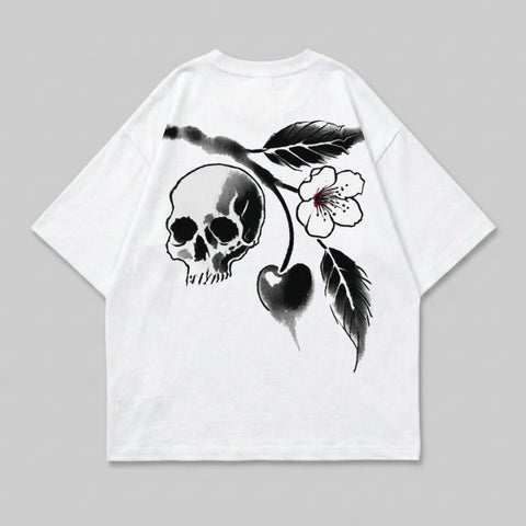 White t-shirt with black skull, cherry, and floral design.