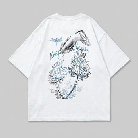 White t-shirt with dragonfly and hand watering plants graphic.
