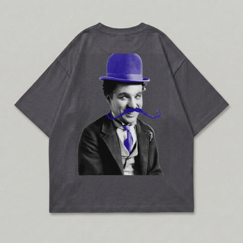 Charlie Chaplin wearing a bowler hat and bowtie, printed on a grey t-shirt.
