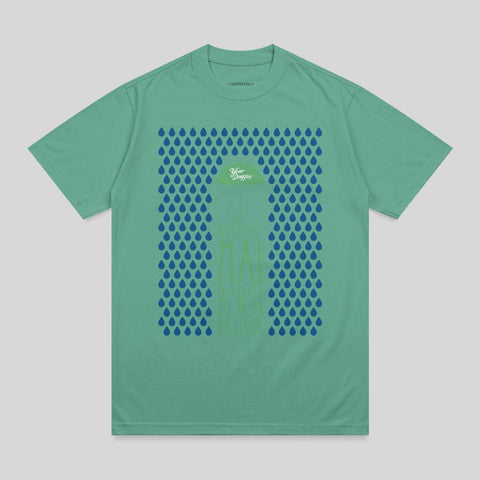 Green t-shirt with blue raindrops and text reading "You Make Me Sing".