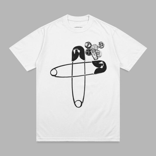 White t-shirt with a large black safety pin and multiple small pins.