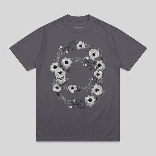 Dark gray t-shirt with a floral wreath design featuring white and gray flowers.