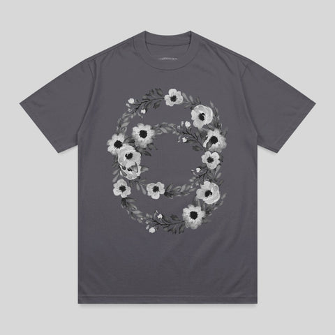 Dark gray t-shirt with a floral wreath design featuring white and gray flowers.