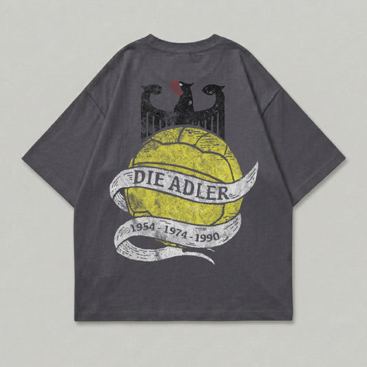 Grey t-shirt with yellow "DIE ADLER" text on a distressed ribbon over a black eagle graphic.